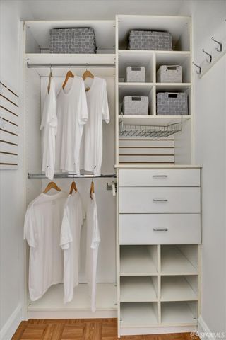 a view of walk in closet with empty racks