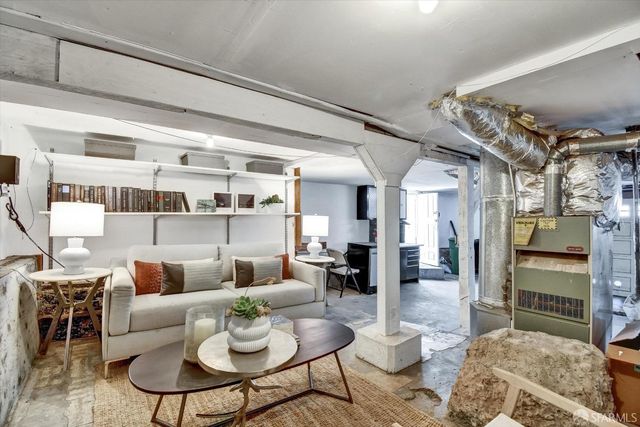 a living room with furniture and a kitchen view