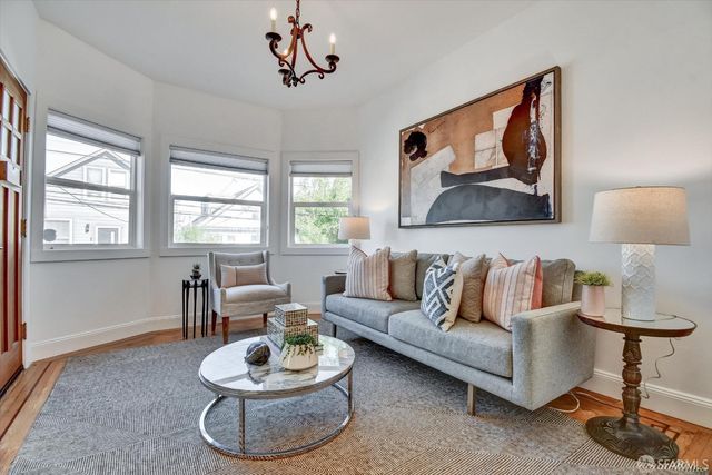 a living room with furniture a window and a lamp