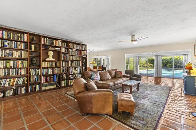 a living room with furniture a rug and a large window