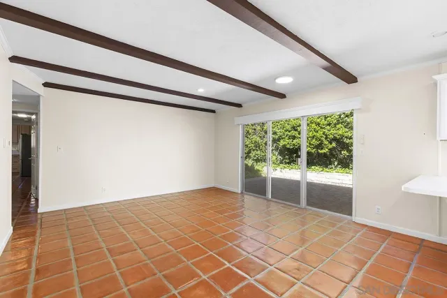 a view of a livingroom with a ceiling fan and a large window