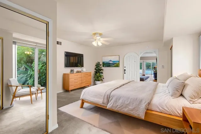 a bathroom with a granite countertop toilet sink and mirror