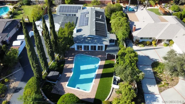 an aerial view of multiple houses with yard