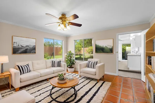 a kitchen with a sink a refrigerator and cabinets