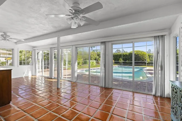 a view of backyard with barbeque grill and wooden fence