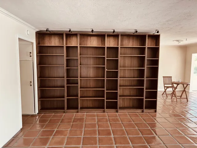 a view of a patio with table and chairs potted plants