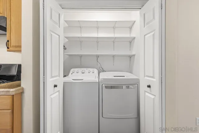 a view of a patio with table and chairs potted plants with wooden floor and fence