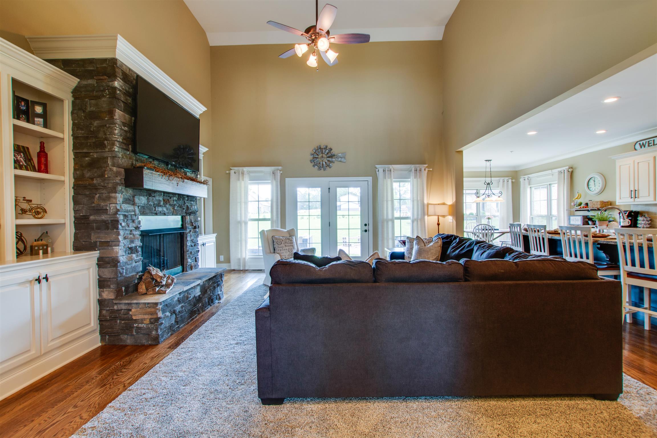 9610 Mona Road Murfreesboro, TN 37129 - Photo 6 of 30 Featuring custom built-ins, a large stone fireplace, a loft balcony, and access to your back patio through the living room!