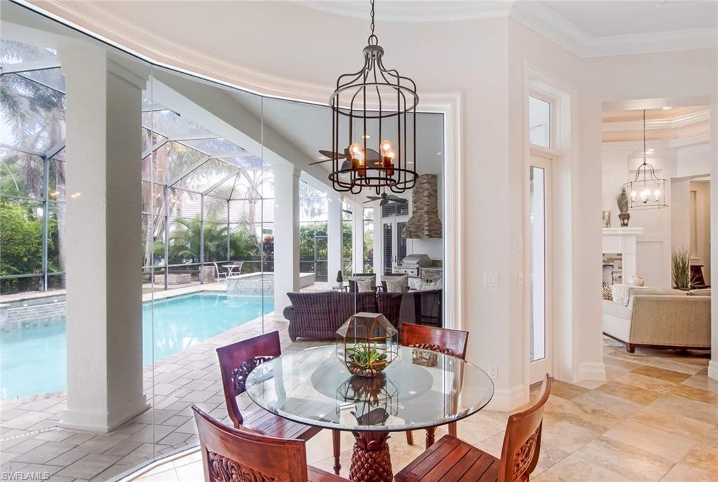 516 Portside Drive Naples, FL 34103 - Photo 12 of 25 a view of a dining room with furniture window and outside view