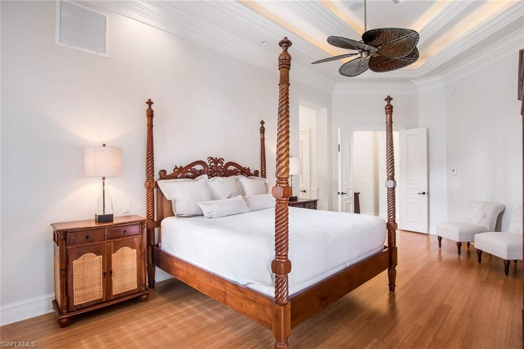 516 Portside Drive Naples, FL 34103 - Photo 16 of 25 a bedroom with a bed and a chandelier