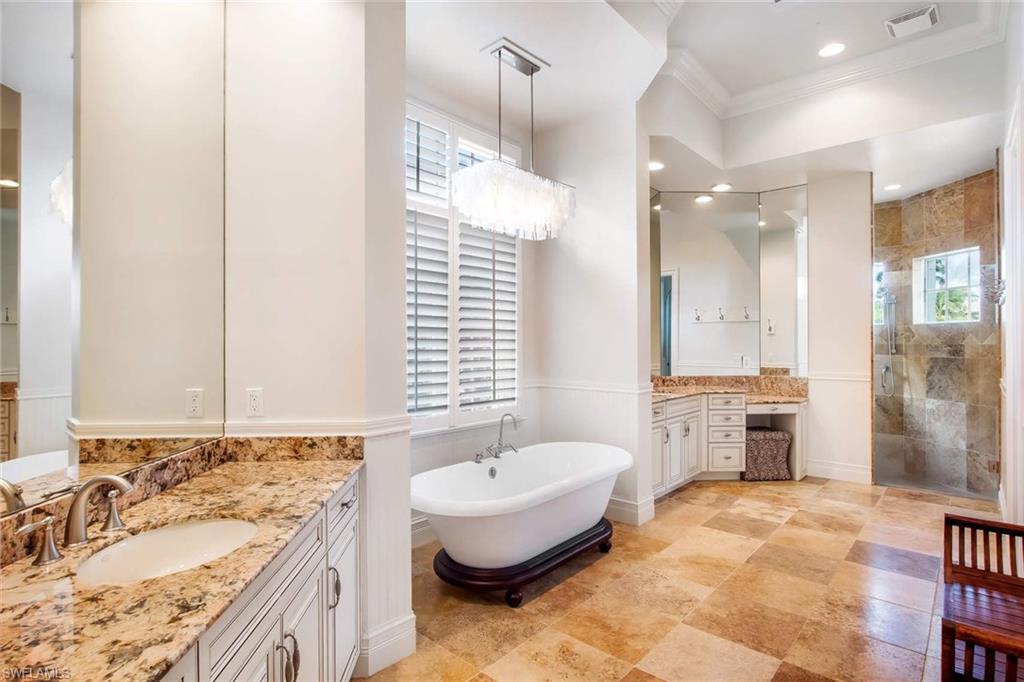 516 Portside Drive Naples, FL 34103 - Photo 18 of 25 a bathroom with a tub sink and mirror