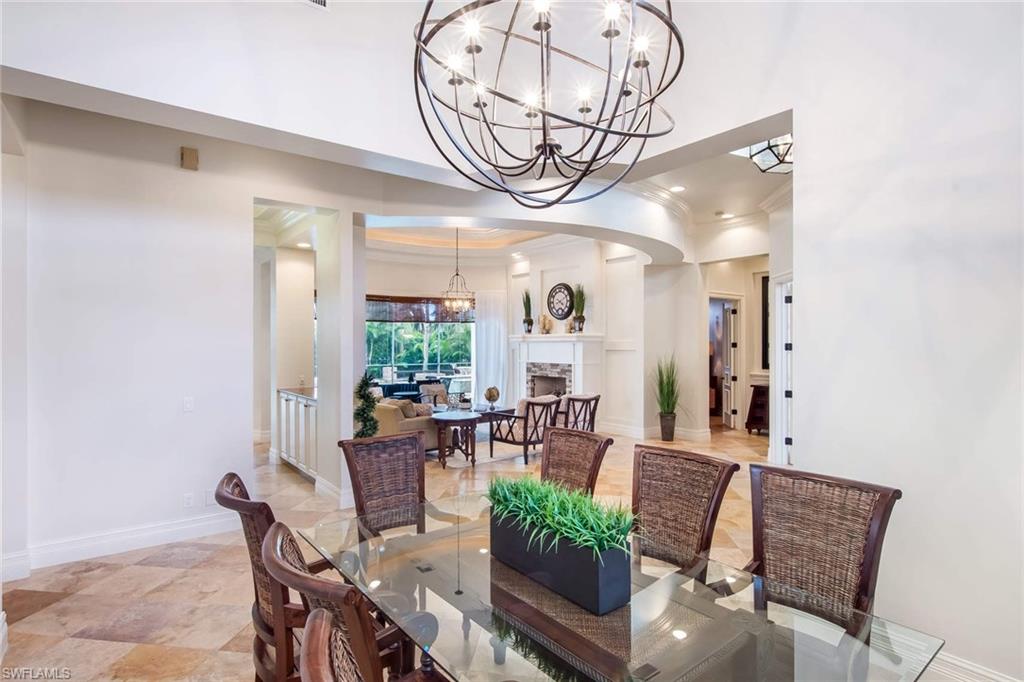 516 Portside Drive Naples, FL 34103 - Photo 6 of 25 a view of a dining room with furniture window and wooden floor