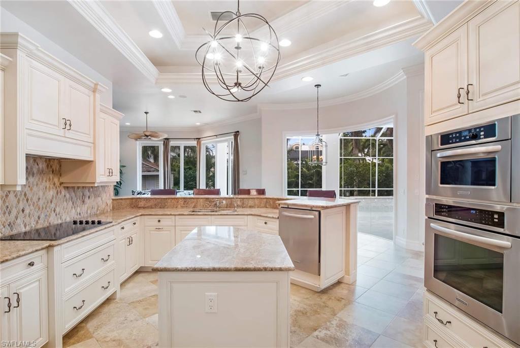 516 Portside Drive Naples, FL 34103 - Photo 8 of 25 a kitchen with stainless steel appliances granite countertop a stove and cabinets