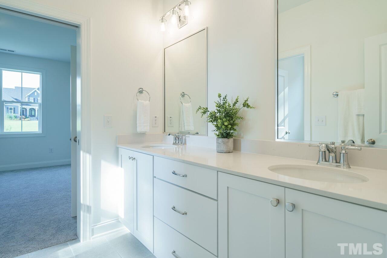 1429 Blantons Creek Drive Wake Forest, NC 27587 - Photo 15 of 40 a bathroom with a sink and a mirror