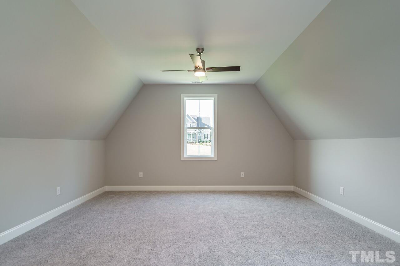 1429 Blantons Creek Drive Wake Forest, NC 27587 - Photo 19 of 40 an empty room with a window and a chandelier fan