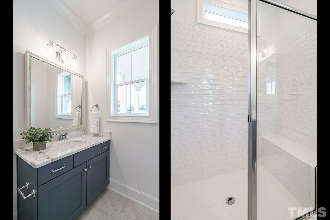 1429 Blantons Creek Drive Wake Forest, NC 27587 - Photo 28 of 40 a bathroom with a granite countertop sink a mirror and a shower