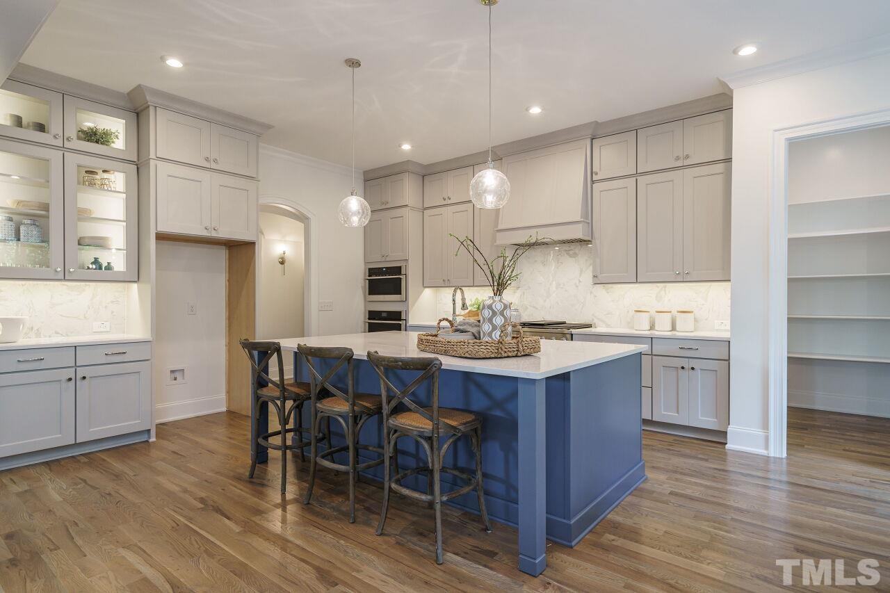 1429 Blantons Creek Drive Wake Forest, NC 27587 - Photo 34 of 40 a kitchen with a sink stove cabinets and wooden floor