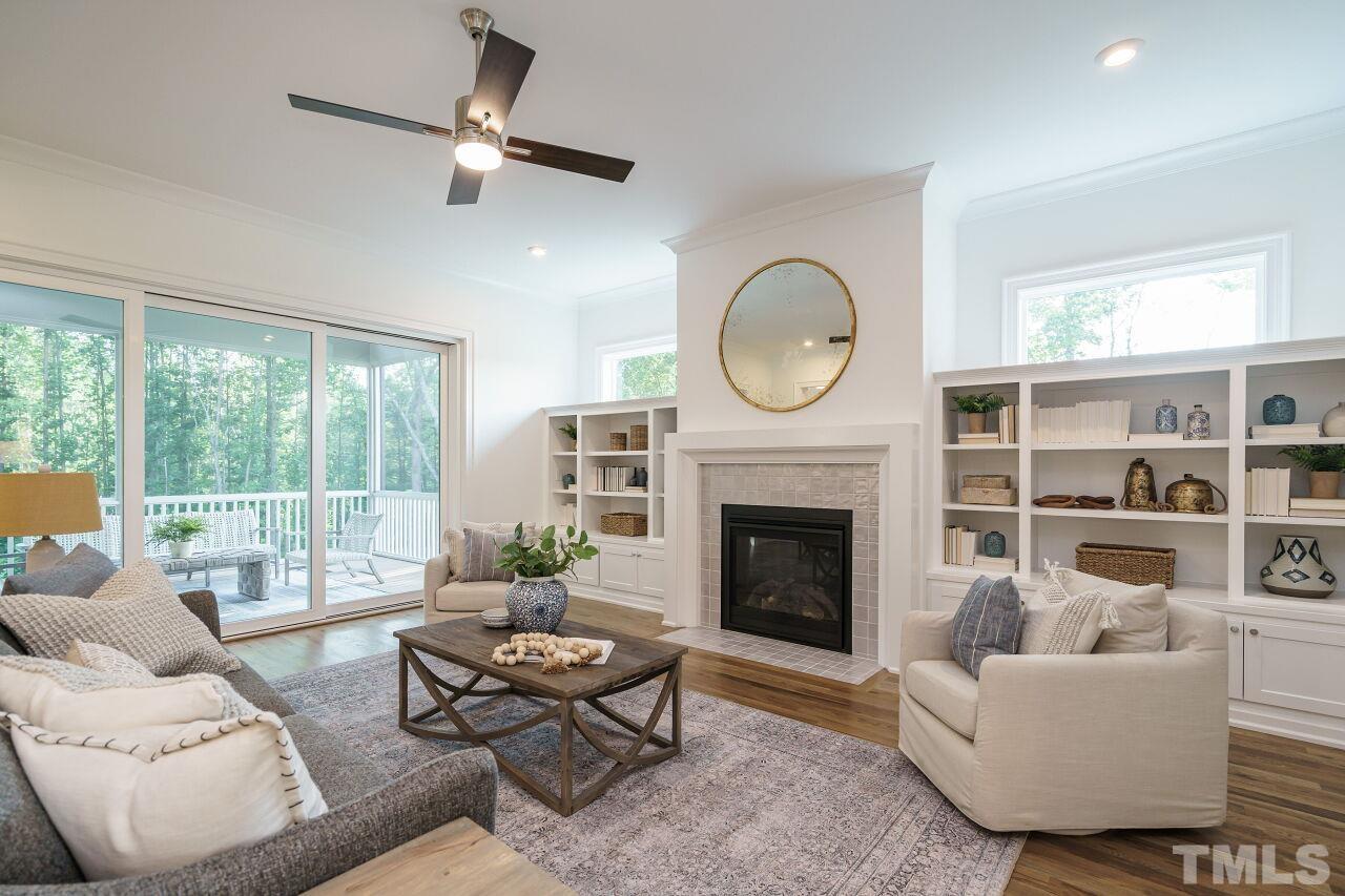 1429 Blantons Creek Drive Wake Forest, NC 27587 - Photo 37 of 40 a living room with furniture a fireplace and a large window