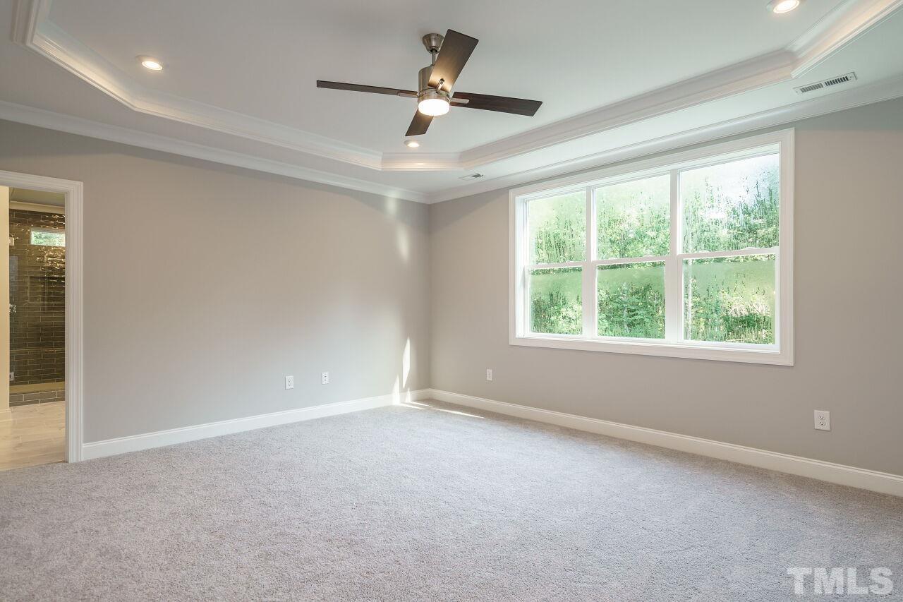 1429 Blantons Creek Drive Wake Forest, NC 27587 - Photo 7 of 40 en empty room with windows and ceiling fan