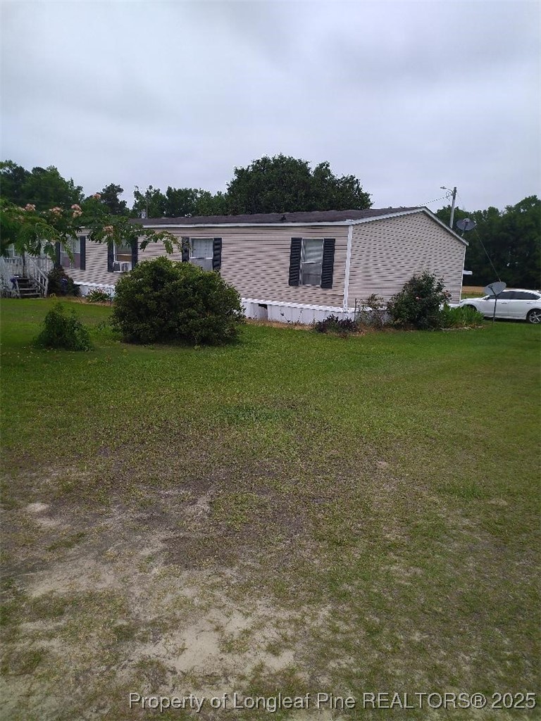 887 Stephens Road Lumberton, NC 28358 - Photo 1 of 9 a view of a house with a backyard