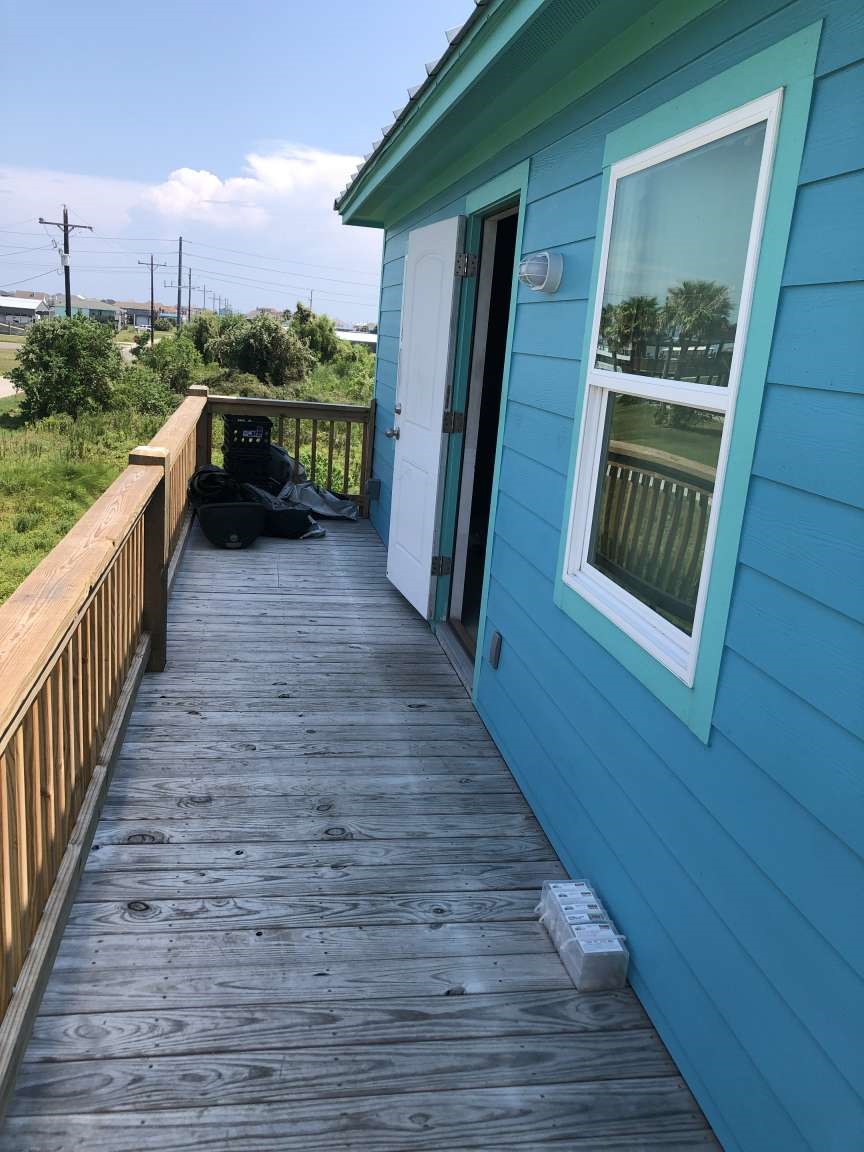 1021 North Sage Road Crystal Beach, TX 77650 - Photo 4 of 7 a view of balcony with wooden floor and fence