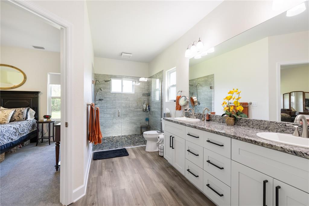 5149 Southwest 119th Road Lake Butler, FL 32054 - Photo 23 of 40 a bathroom with a double vanity sink and a mirror