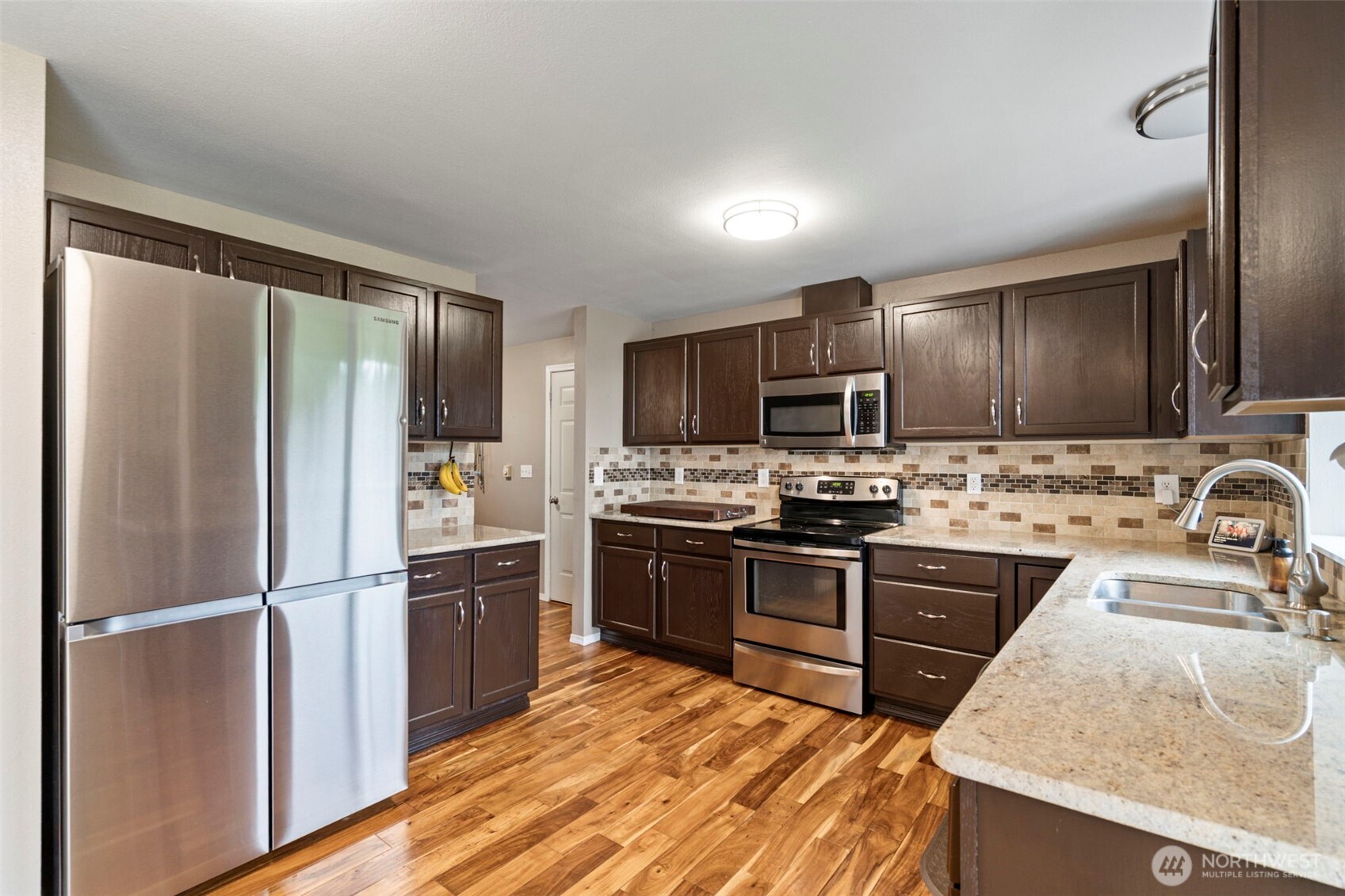 140 Garrett Loop Chehalis, WA 98532 - Photo 16 of 38 a kitchen with stainless steel appliances granite countertop a refrigerator stove microwave and sink