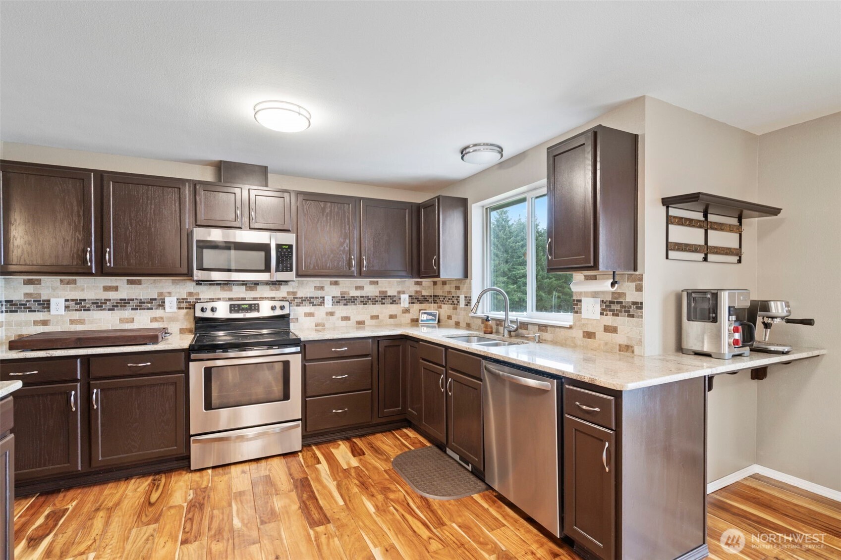 140 Garrett Loop Chehalis, WA 98532 - Photo 17 of 38 a kitchen with stainless steel appliances granite countertop a sink stove microwave and cabinets