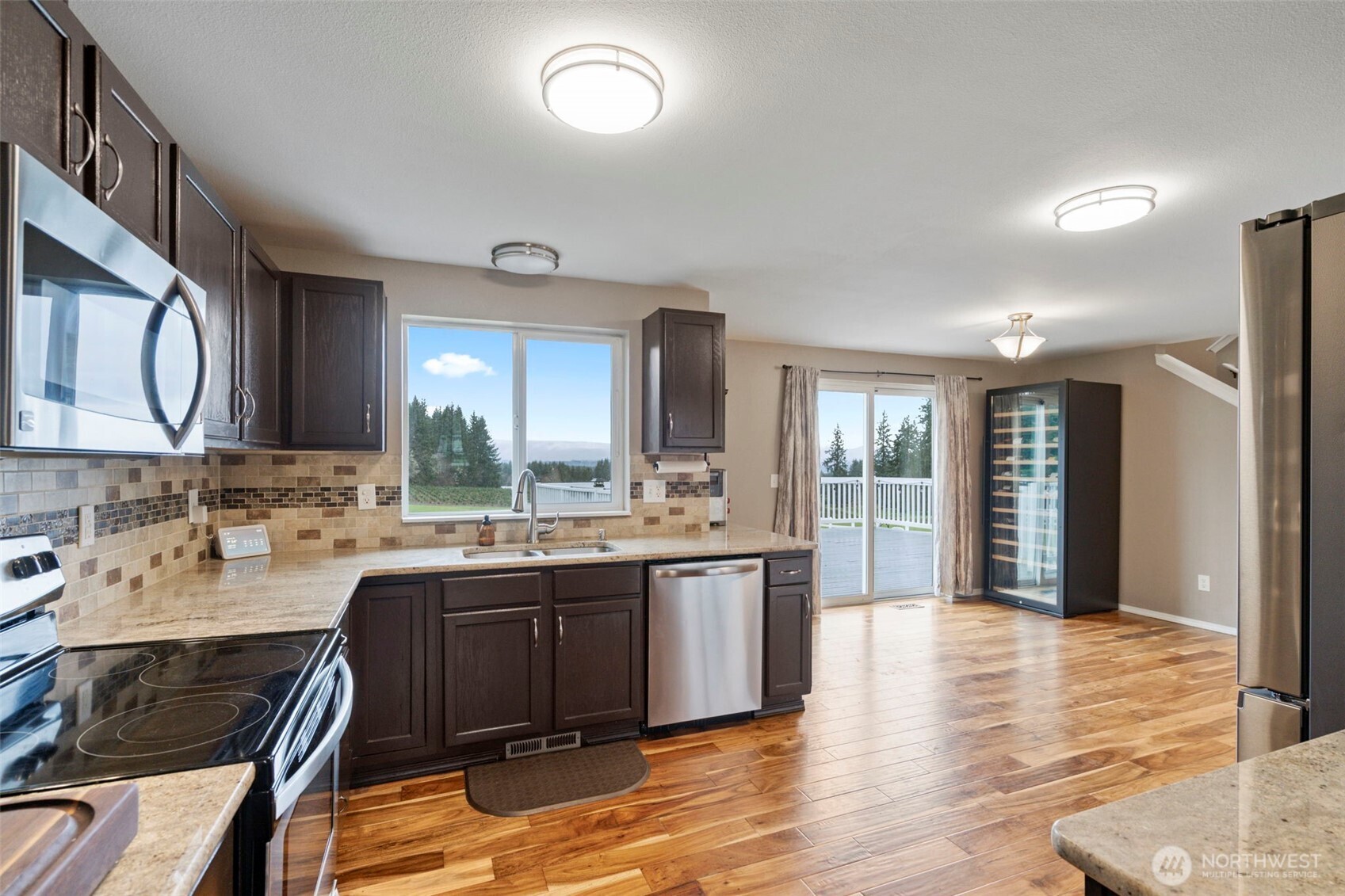 140 Garrett Loop Chehalis, WA 98532 - Photo 18 of 38 a large kitchen with kitchen island a sink stainless steel appliances and cabinets