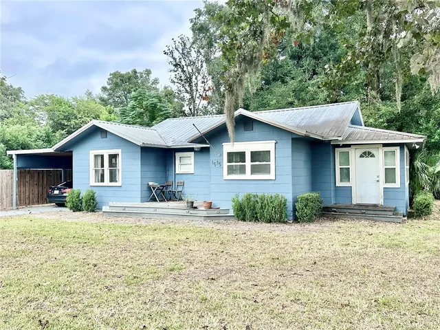 a front view of a house with a yard and porch