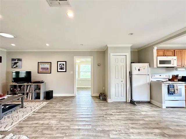 a view of a kitchen with furniture and wooden floor