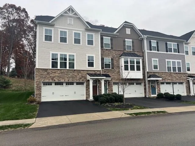 a view of a big house with a street