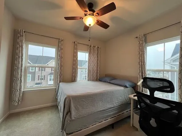 a bedroom with a bed and a window