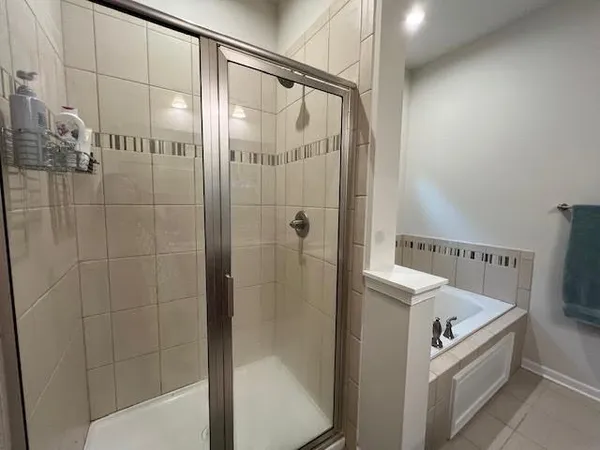 a bathroom with a bathtub and a shower