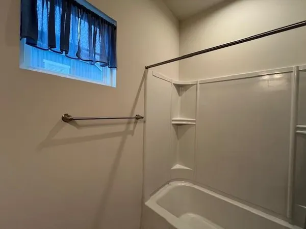 a bathroom with a shower and a bath tub