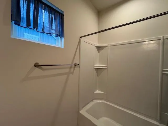 a bathroom with a shower and a bath tub