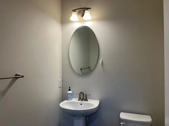 a bathroom with a toilet and a sink