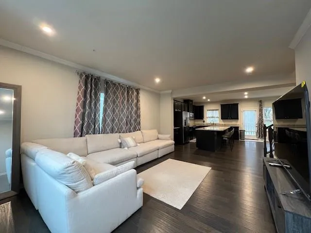a living room with furniture flat screen tv and pool table