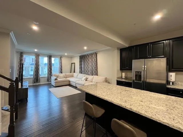 a large kitchen with kitchen island a stove a sink a dining table and chairs