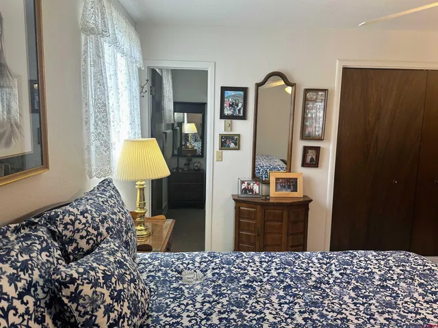 a bedroom with bed and wooden floor