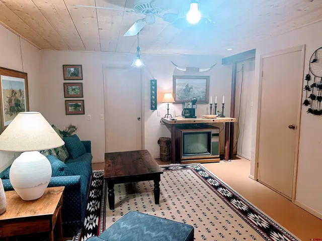 a living room with furniture a dining table and a fireplace