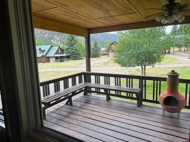 a view of a balcony with wooden floor