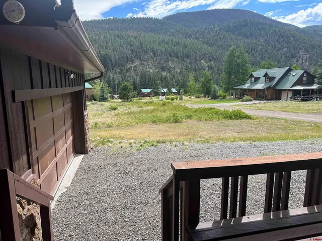 a view of a house with a yard from a balcony