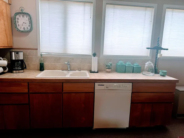 a view of bathroom with a sink and a mirror