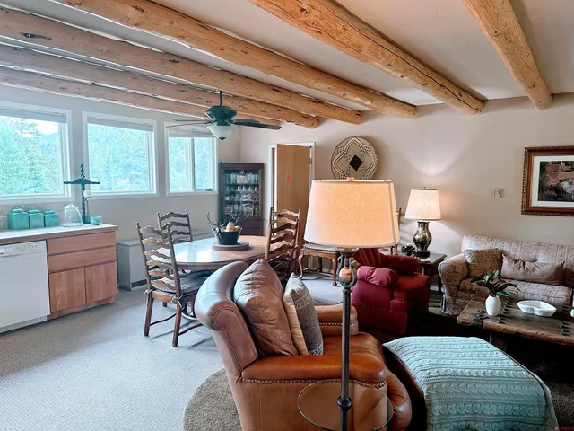a living room with furniture a window and a chandelier