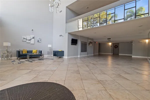 a view of a hallway with a livingroom and entryway