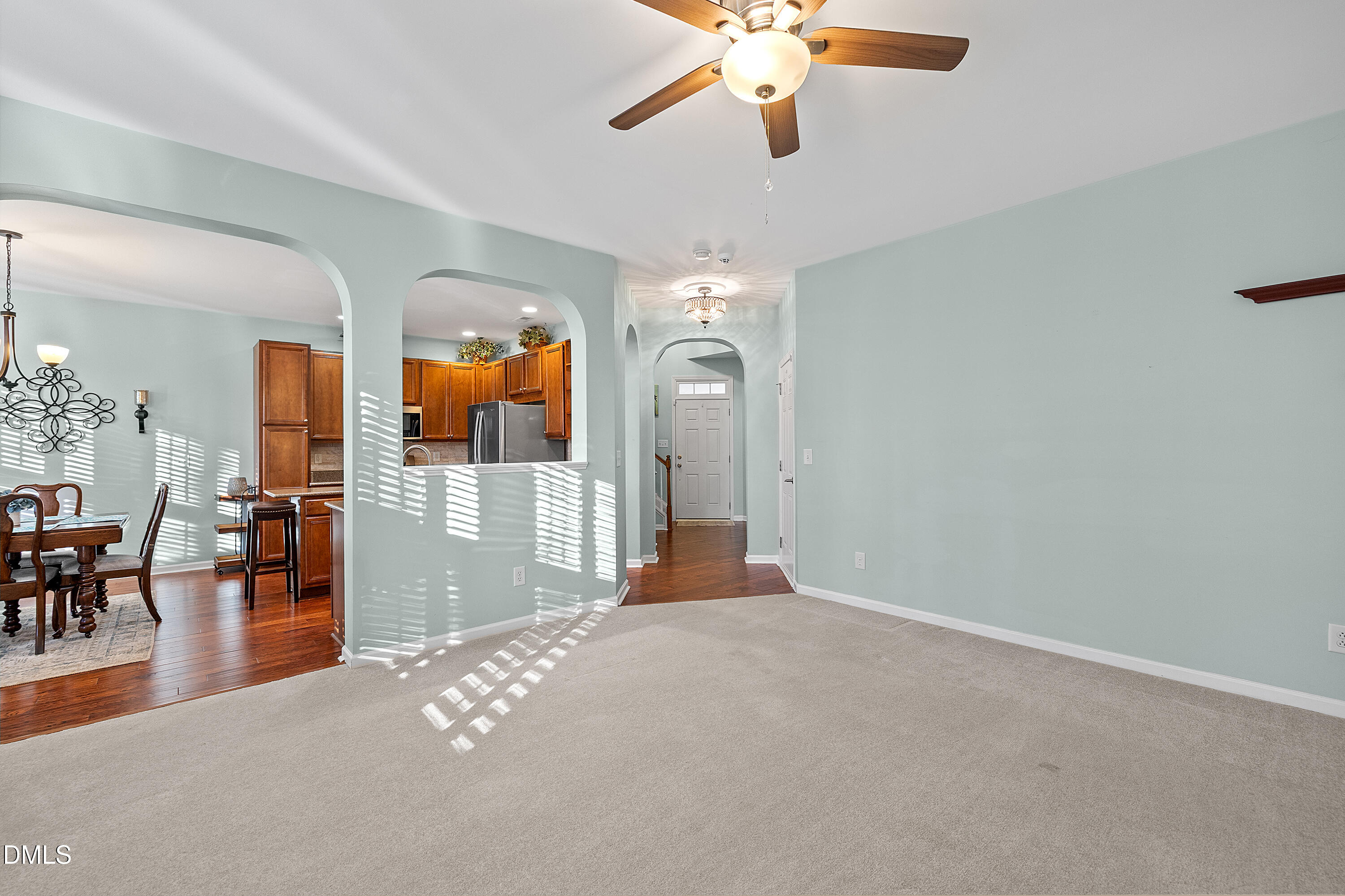 7837 Cape Charles Drive Raleigh, NC 27617 - Photo 10 of 43 wooden floor in an empty room with a chandelier fan