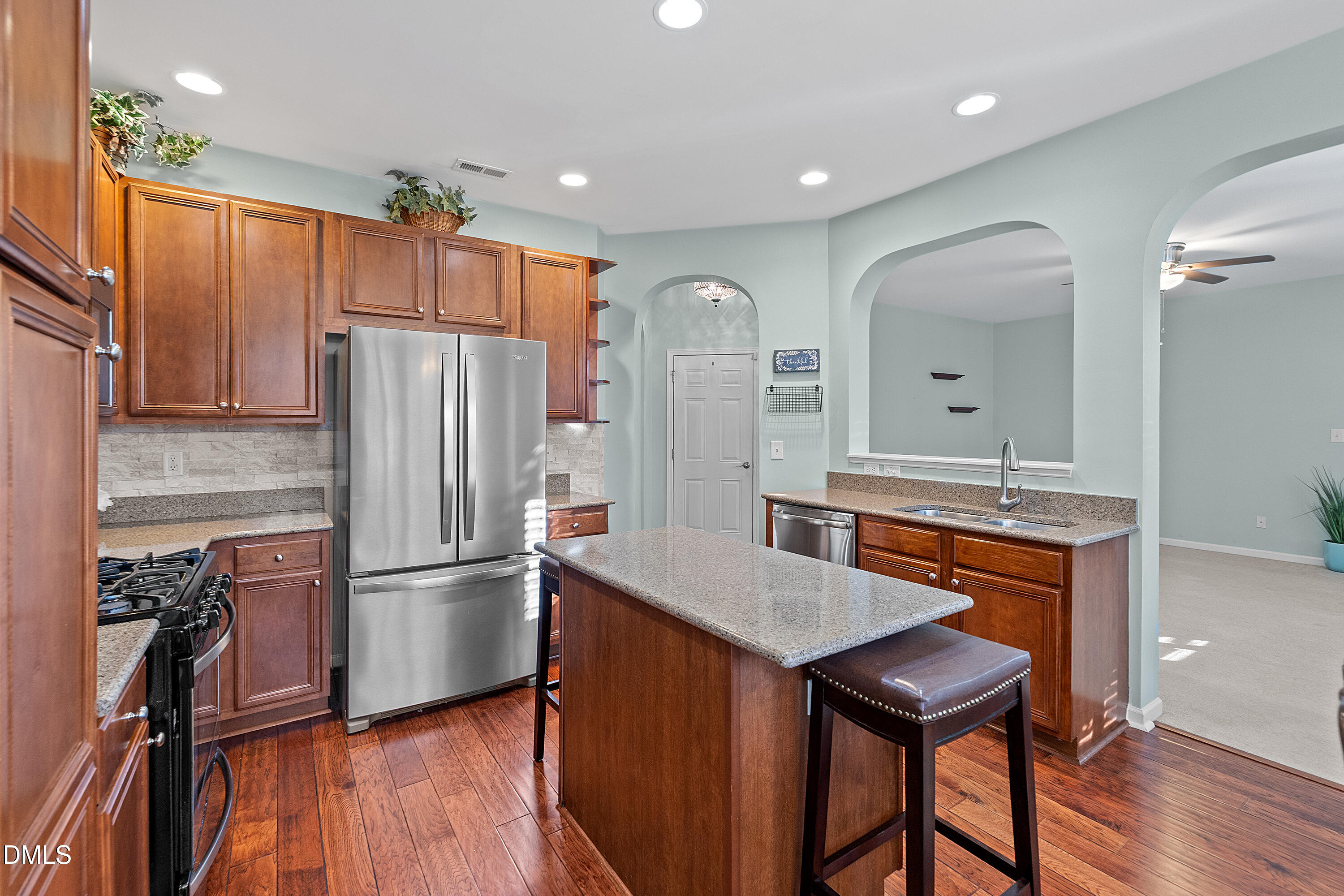 7837 Cape Charles Drive Raleigh, NC 27617 - Photo 13 of 43 a kitchen with refrigerator cabinets and wooden floor