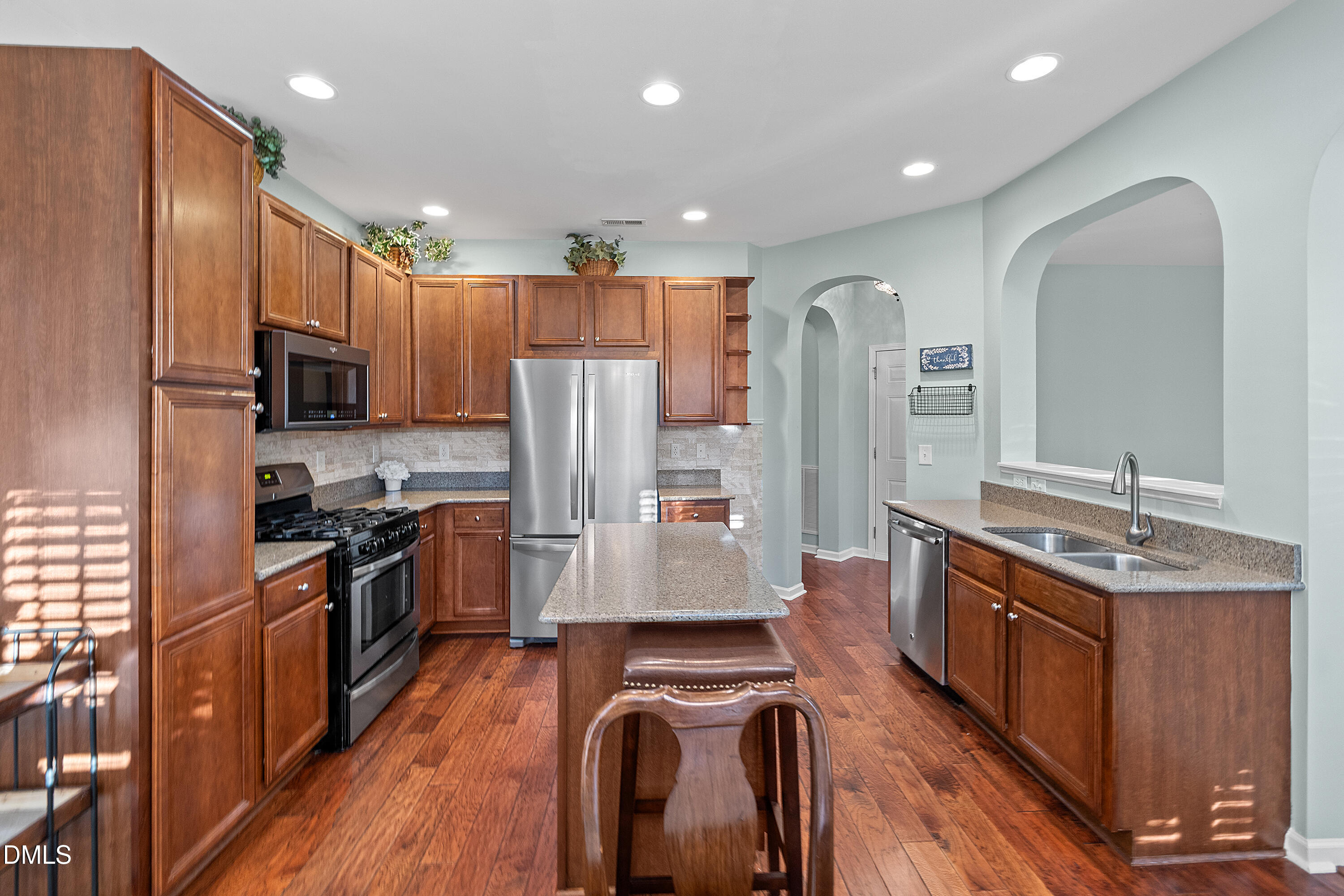 7837 Cape Charles Drive Raleigh, NC 27617 - Photo 13 of 44 a kitchen with stainless steel appliances granite countertop a refrigerator a stove top oven and sink