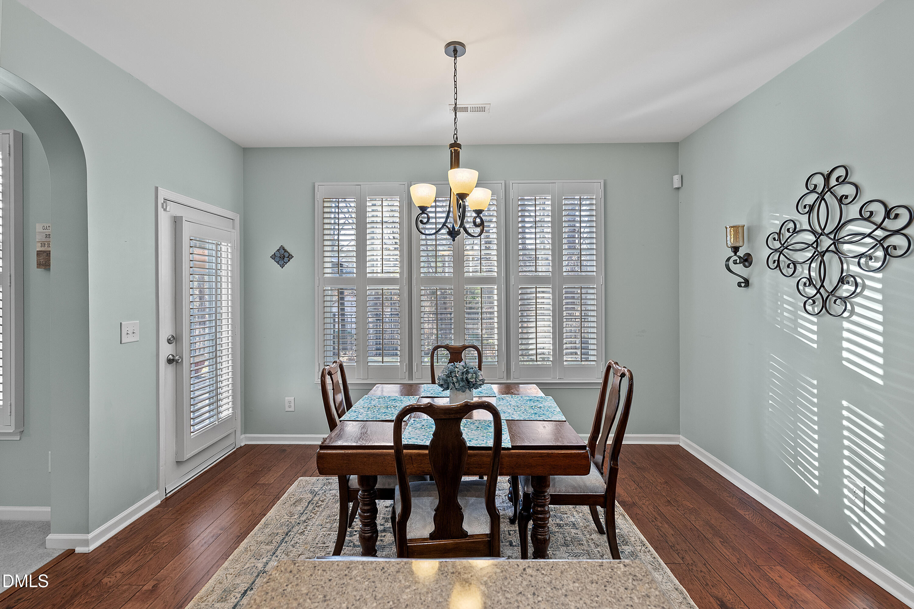 7837 Cape Charles Drive Raleigh, NC 27617 - Photo 16 of 43 a view of a dining room with furniture window and wooden floor